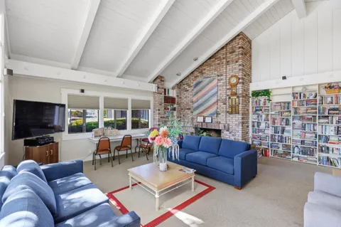 a living room with lots of furniture and wooden floors