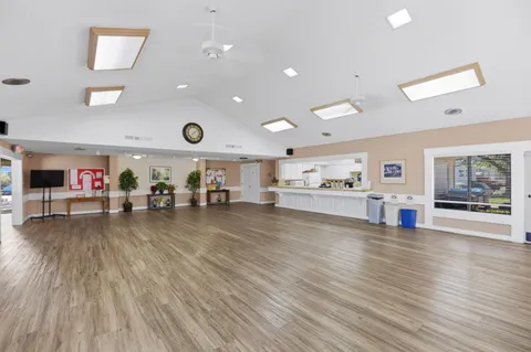 a living room with kitchen island granite countertop furniture and a wooden floor