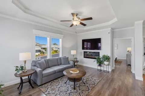 a living room with furniture a window and a flat screen tv