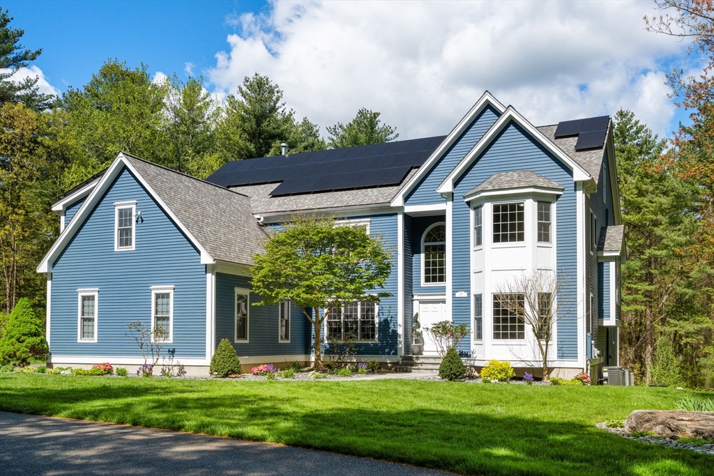 220 Newtown Road Acton, MA 01720 - Photo 2 of 39 a front view of a house with a yard and potted plants