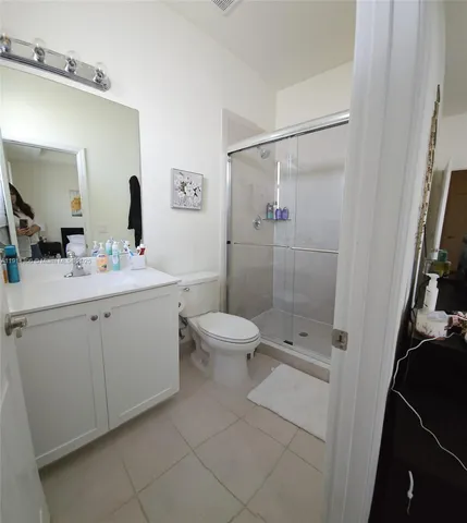 a bathroom with a double vanity sink toilet and shower