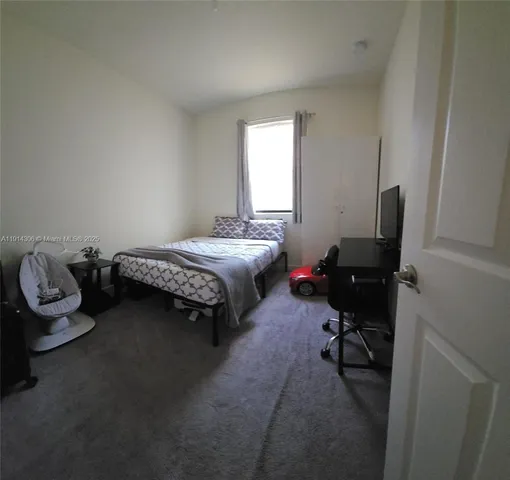 a bed room with a bed and a chair