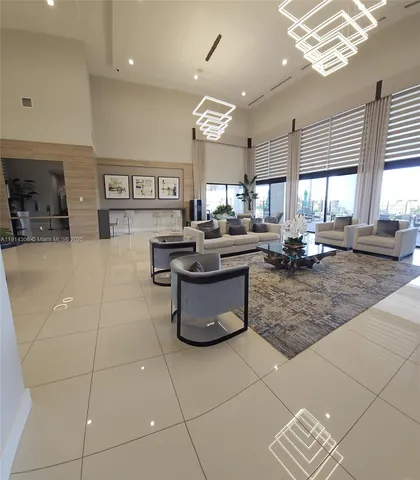 a large kitchen with a counter space a sink appliances and a window