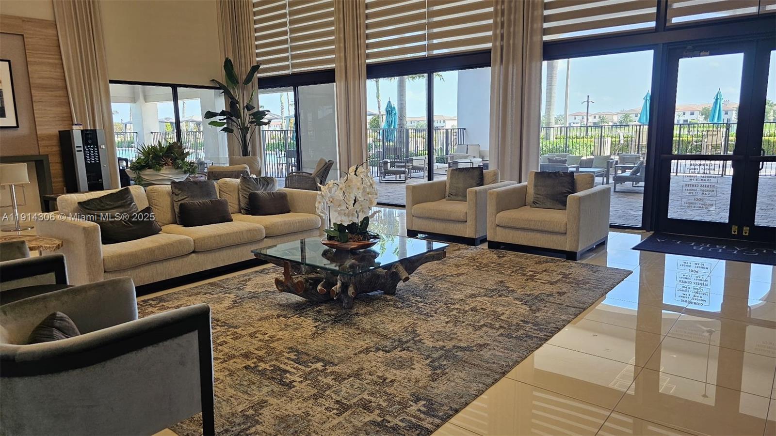 3387 West 106th Terrace, Unit 3387 Hialeah, FL 33018 - Photo 19 of 20 a living room with furniture fireplace and large windows