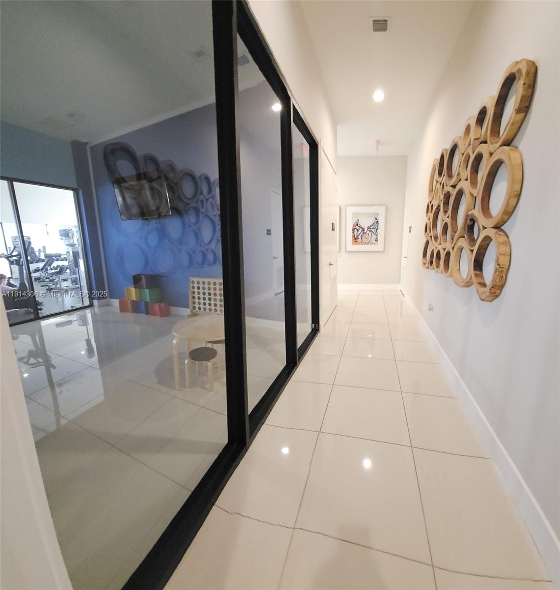 3387 West 106th Terrace, Unit 3387 Hialeah, FL 33018 - Photo 20 of 20 a view of a hallway to a livingroom with furniture