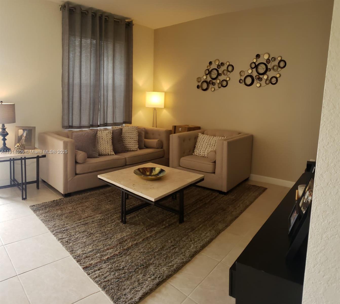 3387 West 106th Terrace, Unit 3387 Hialeah, FL 33018 - Photo 3 of 20 a living room with furniture rug and window