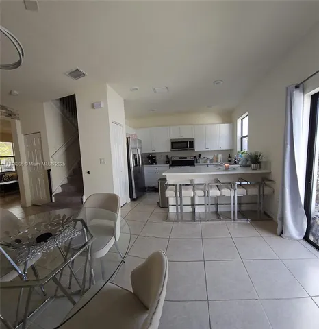 a kitchen with stainless steel appliances a stove a sink a microwave and a refrigerator