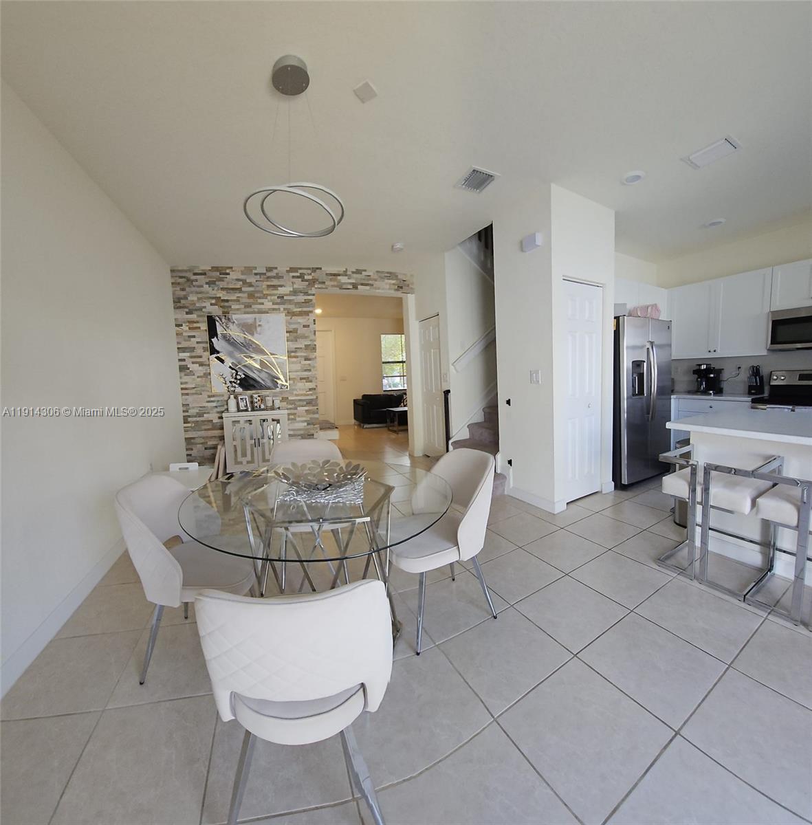 3387 West 106th Terrace, Unit 3387 Hialeah, FL 33018 - Photo 6 of 20 a living room with furniture and a table