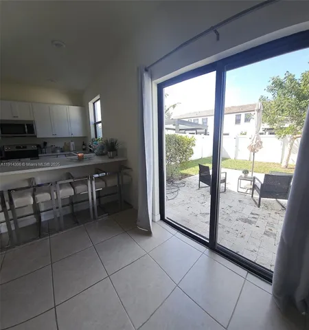 a view of a kitchen with kitchen island granite countertop a fireplace in it