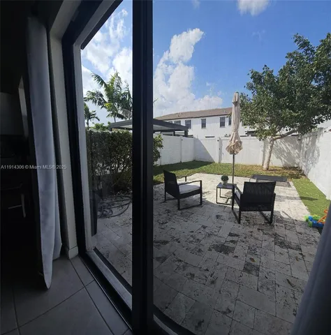 a view of a porch with furniture and yard