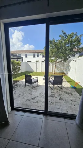 a view of a living room and floor to ceiling window
