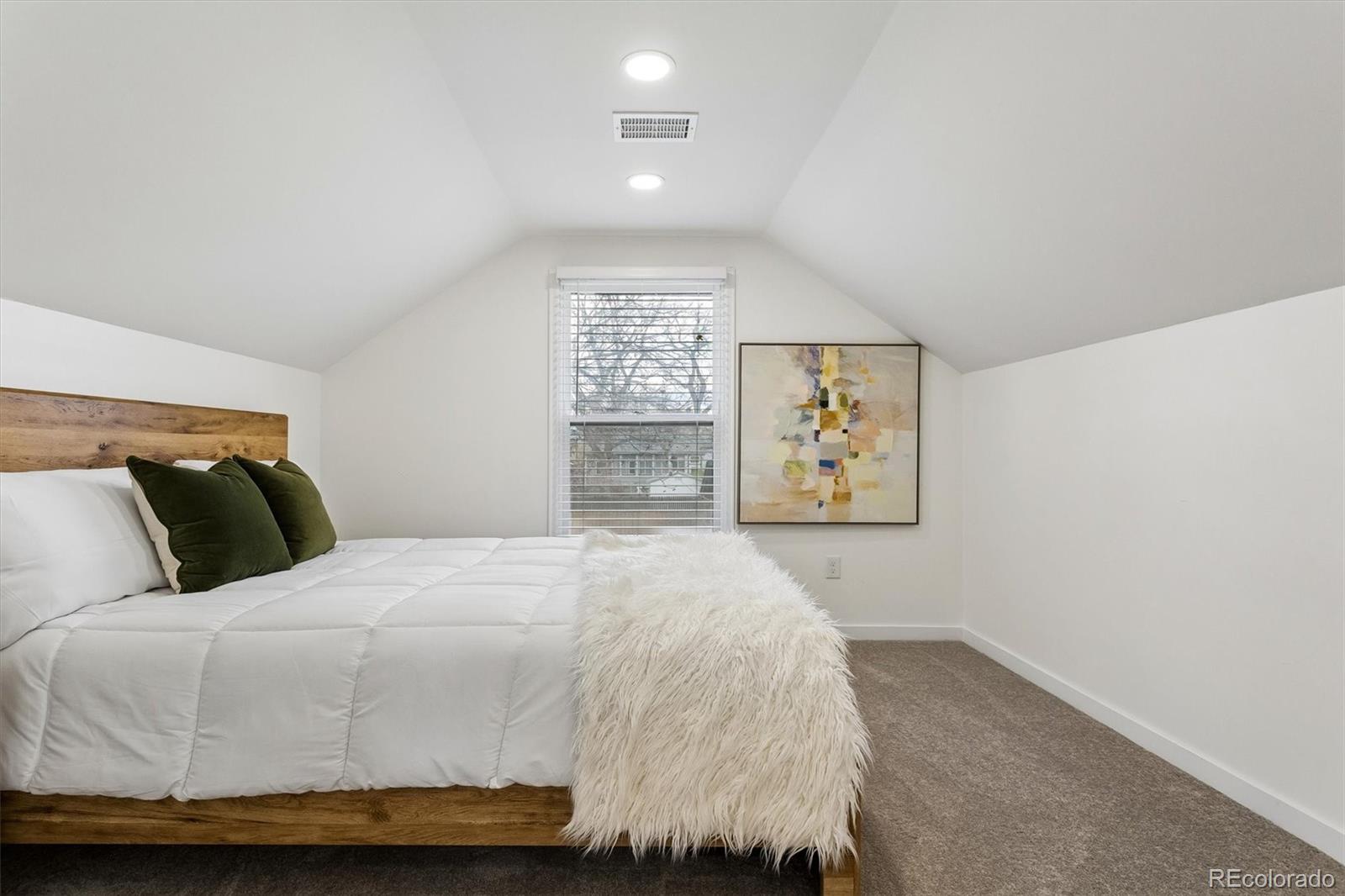 2293 Fenton Street Edgewater, CO 80214 - Photo 11 of 18 a bedroom with a bed and painting on the wall