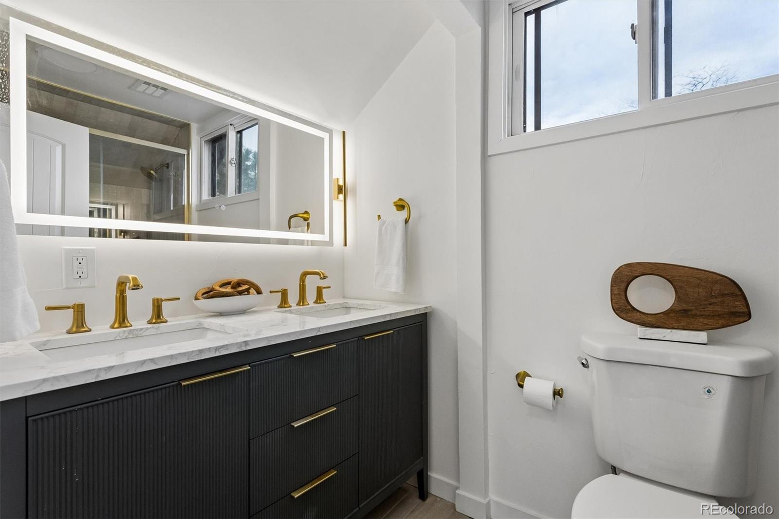 2293 Fenton Street Edgewater, CO 80214 - Photo 13 of 18 a bathroom with a granite countertop sink and a toilet