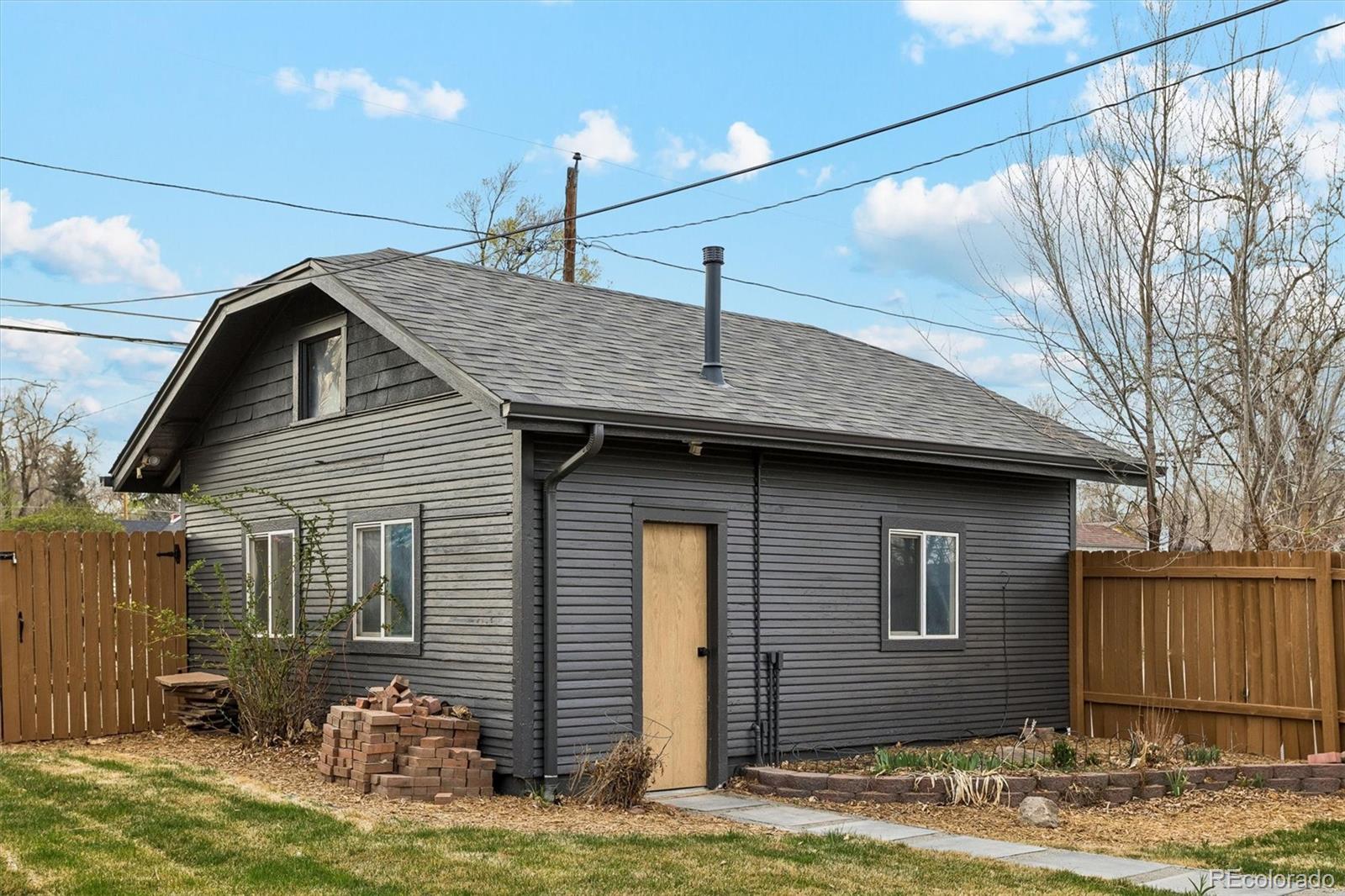 2293 Fenton Street Edgewater, CO 80214 - Photo 17 of 18 a front view of a house with garden