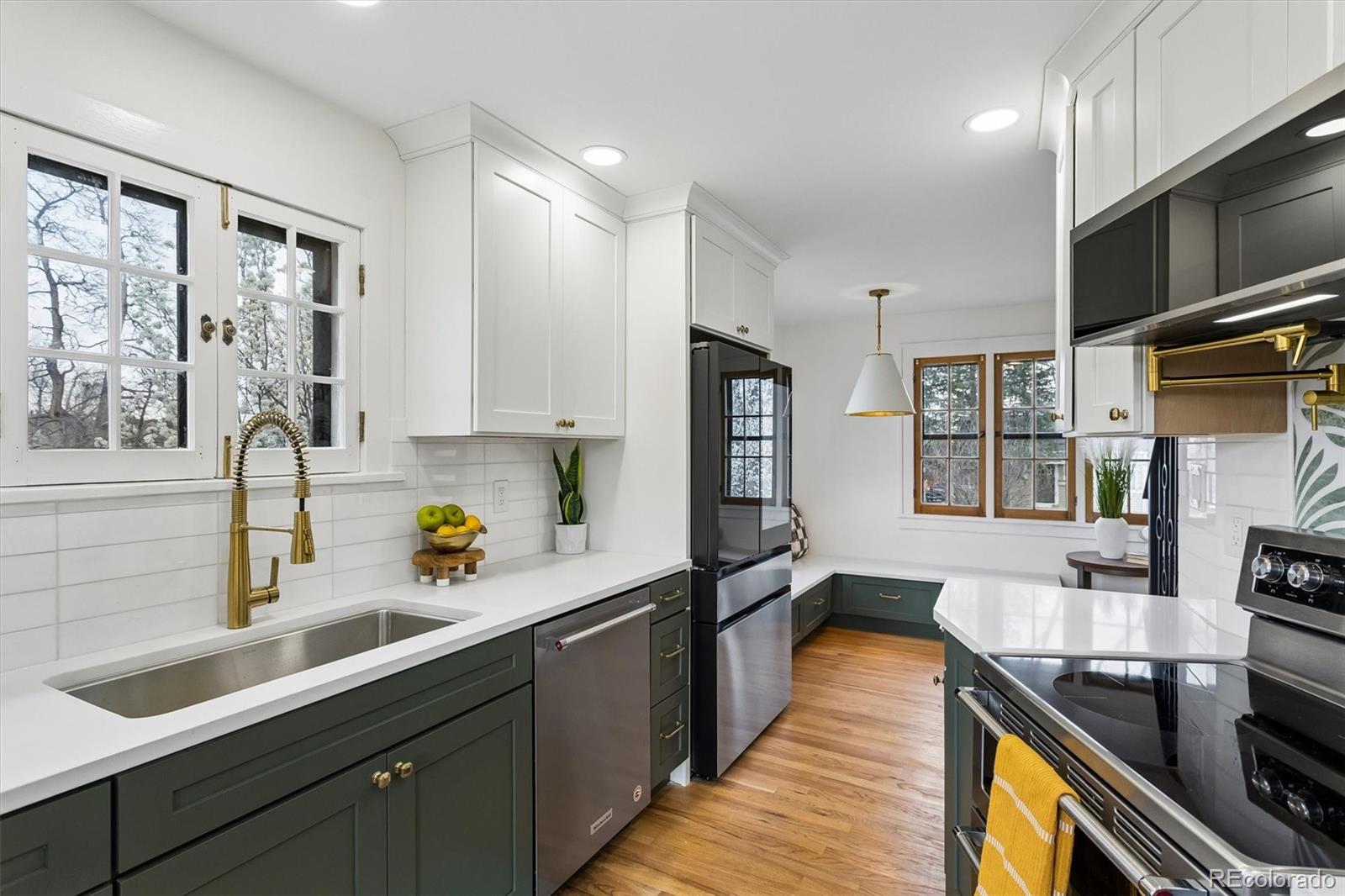 2293 Fenton Street Edgewater, CO 80214 - Photo 4 of 18 a kitchen with stainless steel appliances a sink stove and cabinets