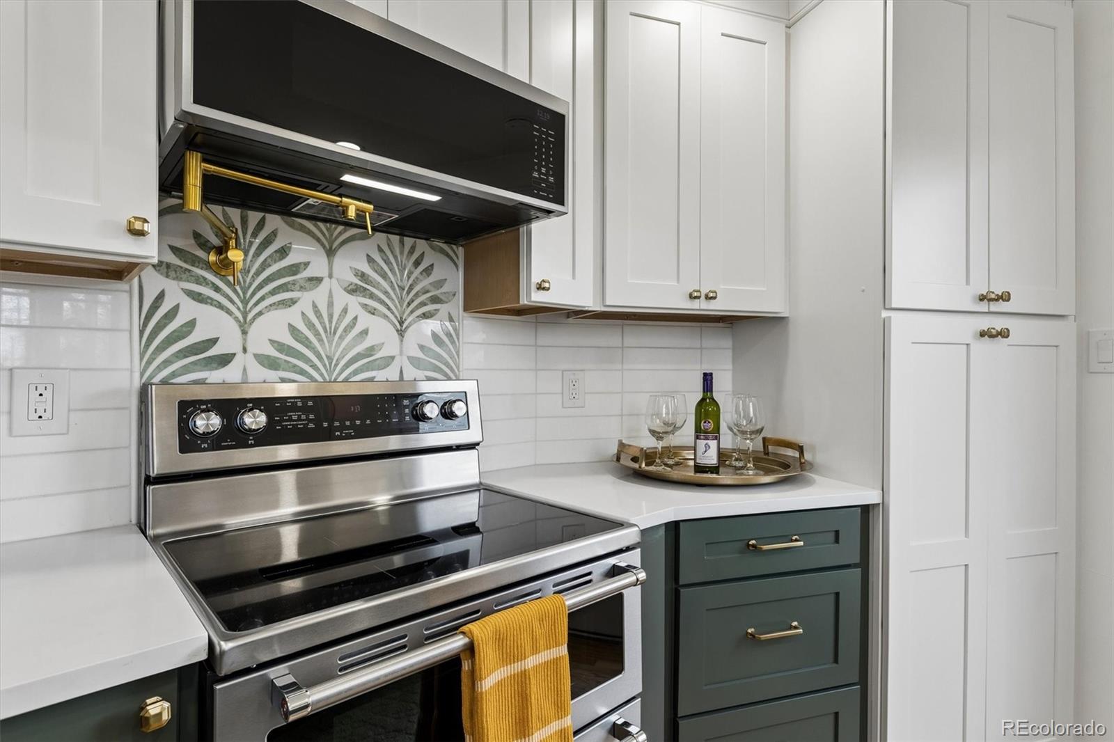 2293 Fenton Street Edgewater, CO 80214 - Photo 5 of 18 a kitchen with stainless steel appliances a stove and a microwave