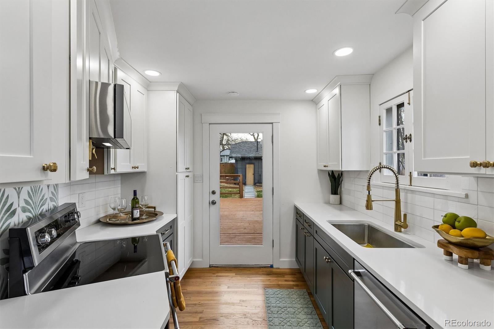 2293 Fenton Street Edgewater, CO 80214 - Photo 6 of 18 a kitchen that has a sink and a stove in it