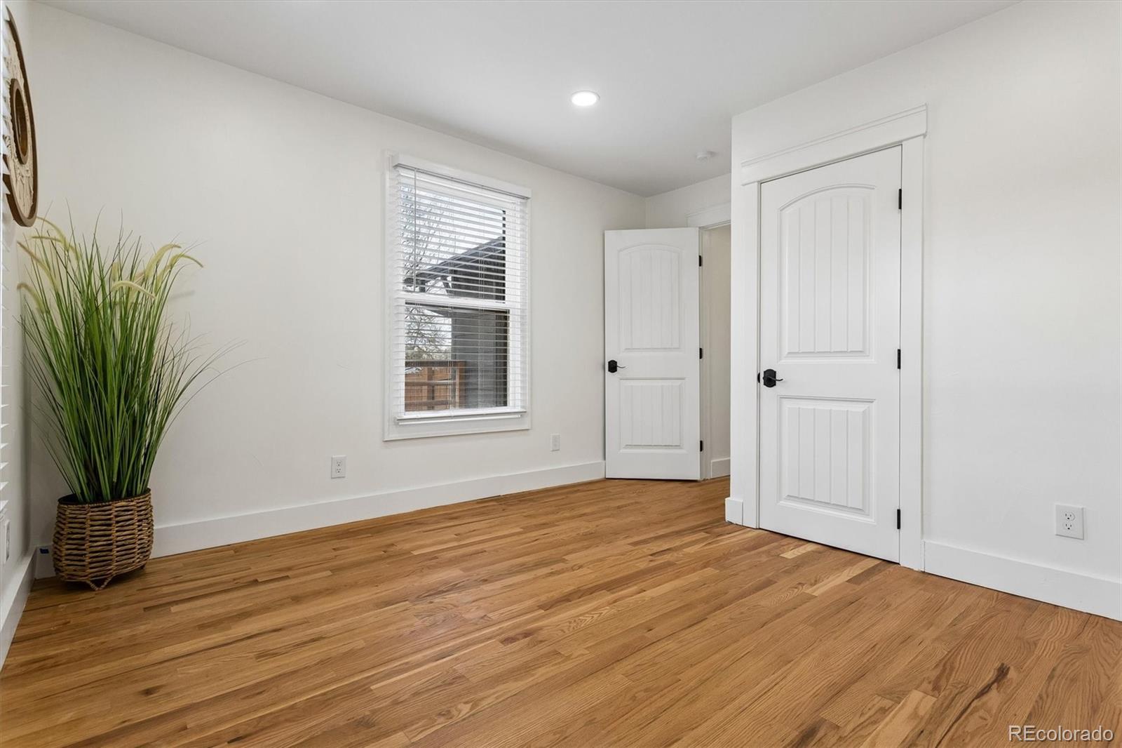 2293 Fenton Street Edgewater, CO 80214 - Photo 7 of 18 a view of an empty room with wooden floor and a window