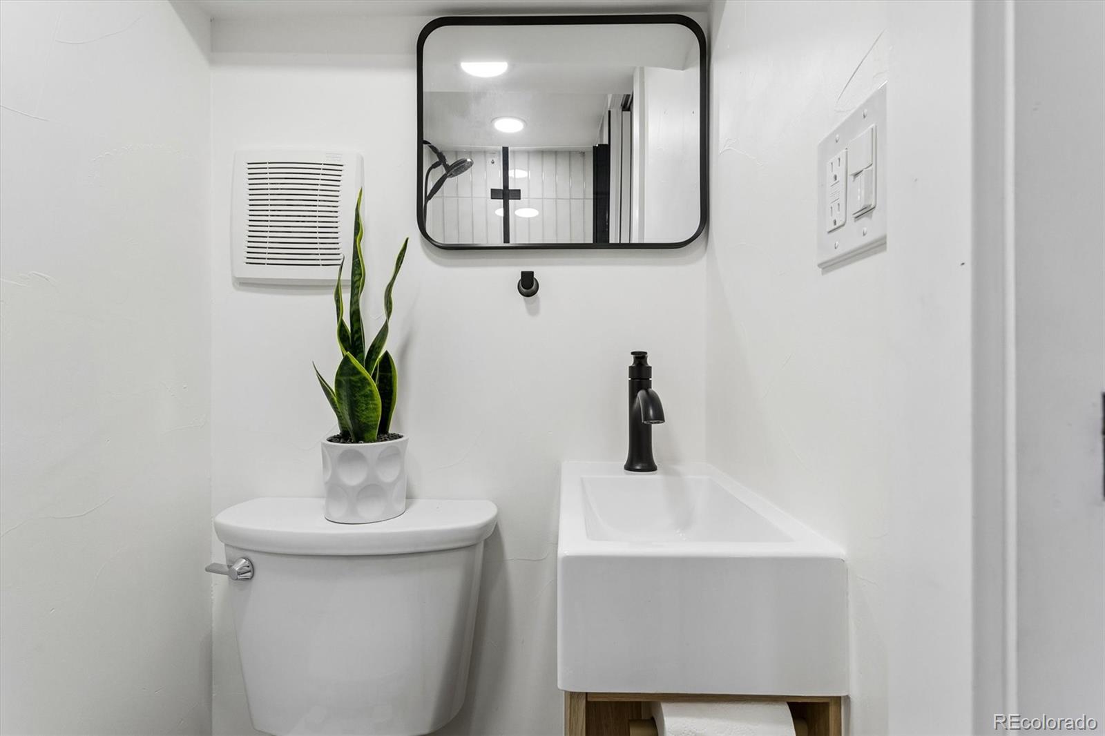 2293 Fenton Street Edgewater, CO 80214 - Photo 9 of 18 a bathroom with a sink and a mirror