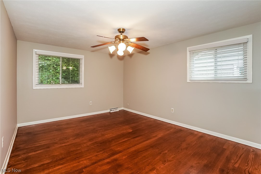 1345 Ford Road Lyndhurst, OH 44124 - Photo 9 of 20 Spare room featuring ceiling fan, dark hardwood / wood-style flooring, and a healthy amount of sunlight