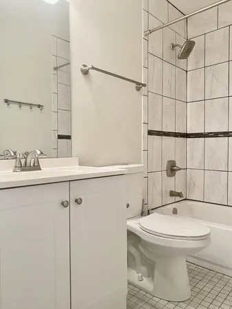 a bathroom with a toilet sink and shower