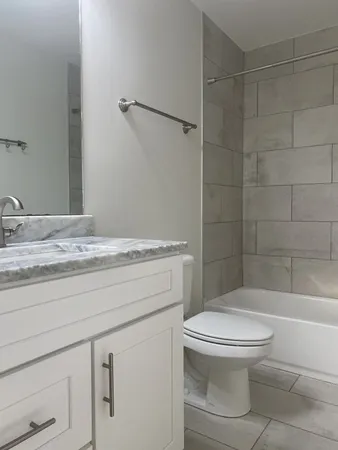 a bathroom with a toilet a sink and shower