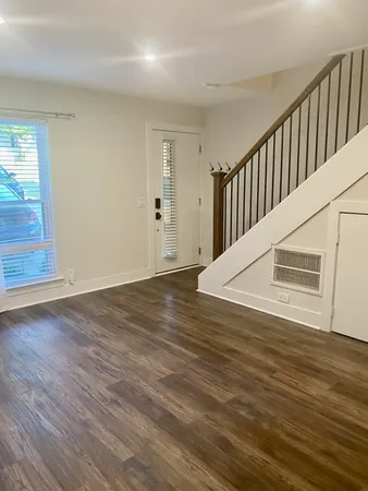 a view of staircase with white walls and wooden floor