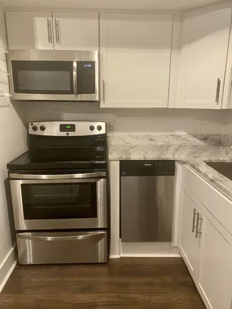 a stove top oven sitting inside of a kitchen