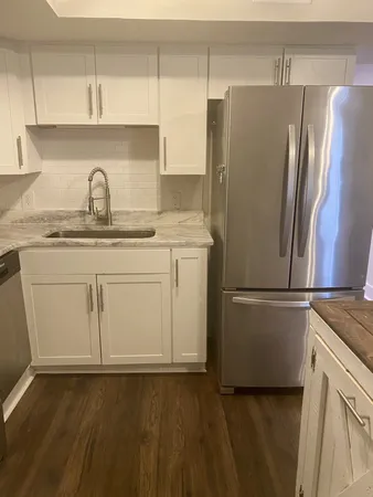 a white refrigerator freezer sitting inside of a kitchen