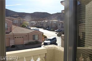 207 Priority Point Street Henderson, NV 89012 - Photo 20 of 23 Scenic mountain vistas and neighborhood views framed by a private balcony window.