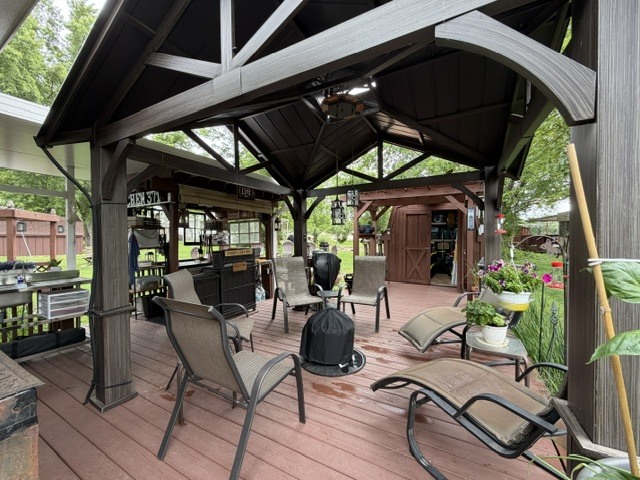 2795 East 28th Road Marseilles, IL 61341 - Photo 31 of 91 a view of a patio with table and chairs under an umbrella with a small yard