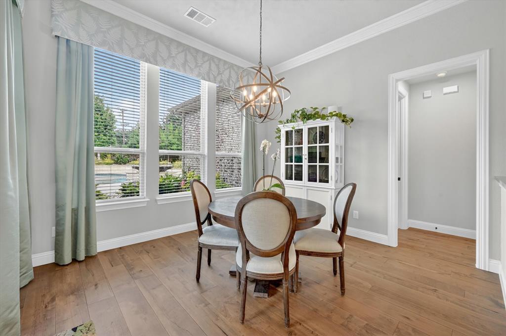 6656 Roughleaf Ridge Road Flower Mound, TX 76226 - Photo 15 of 40 a view of a dining room with furniture window and wooden floor