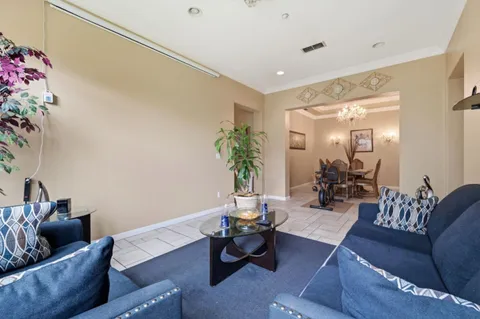 a living room with furniture and flowers