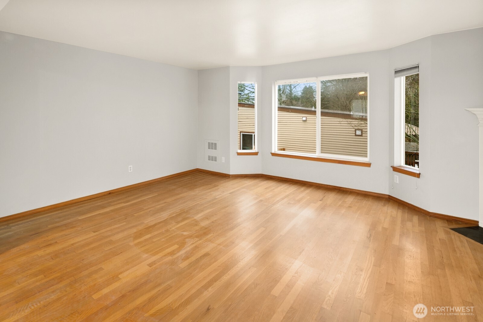 1417 North 97th Street Seattle, WA 98103 - Photo 11 of 23 a view of an empty room with wooden floor and a window