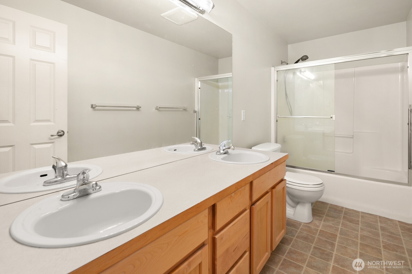 1417 North 97th Street Seattle, WA 98103 - Photo 16 of 23 a bathroom with a double vanity sink toilet and shower