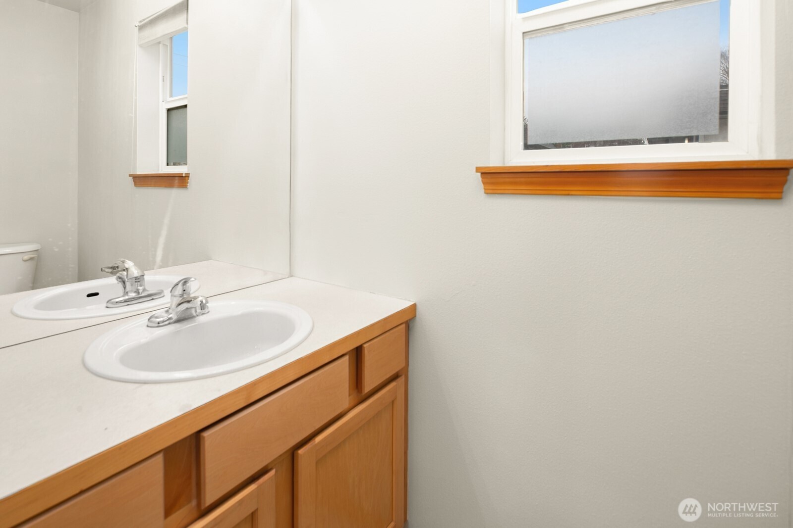 1417 North 97th Street Seattle, WA 98103 - Photo 22 of 23 a bathroom with a sink and a mirror