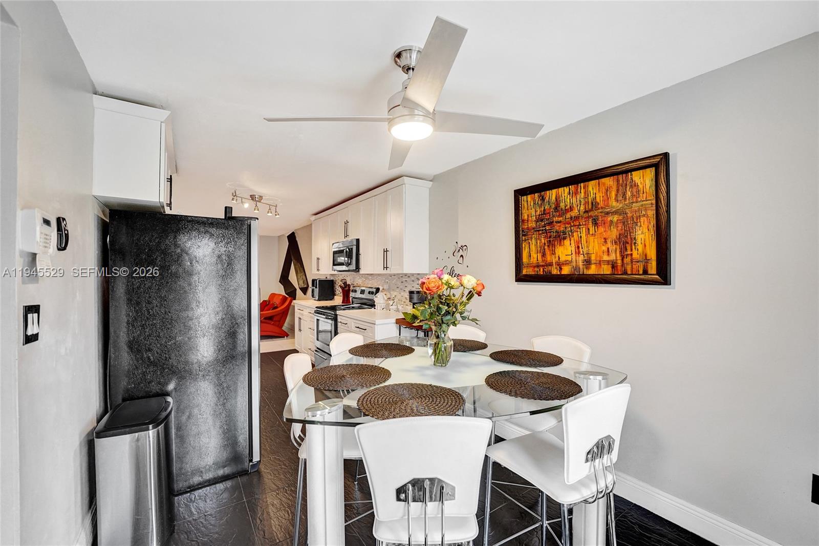 3301 Raleigh Street, Unit 4E Hollywood, FL 33021 - Photo 12 of 80 a kitchen with stainless steel appliances granite countertop a dining table and chairs