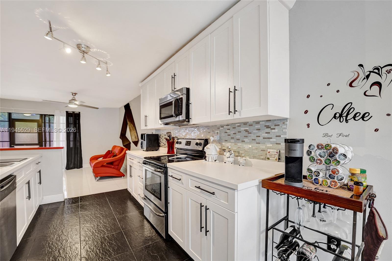 3301 Raleigh Street, Unit 4E Hollywood, FL 33021 - Photo 15 of 80 a kitchen with stainless steel appliances granite countertop a stove and cabinets