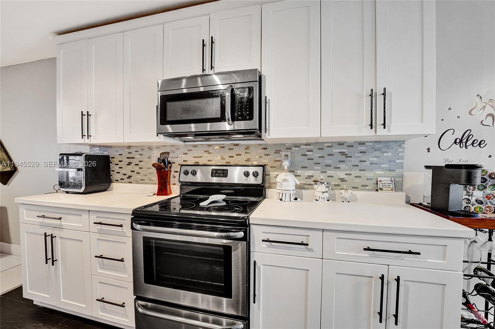 3301 Raleigh Street, Unit 4E Hollywood, FL 33021 - Photo 18 of 80 a kitchen with stainless steel appliances a stove microwave and sink