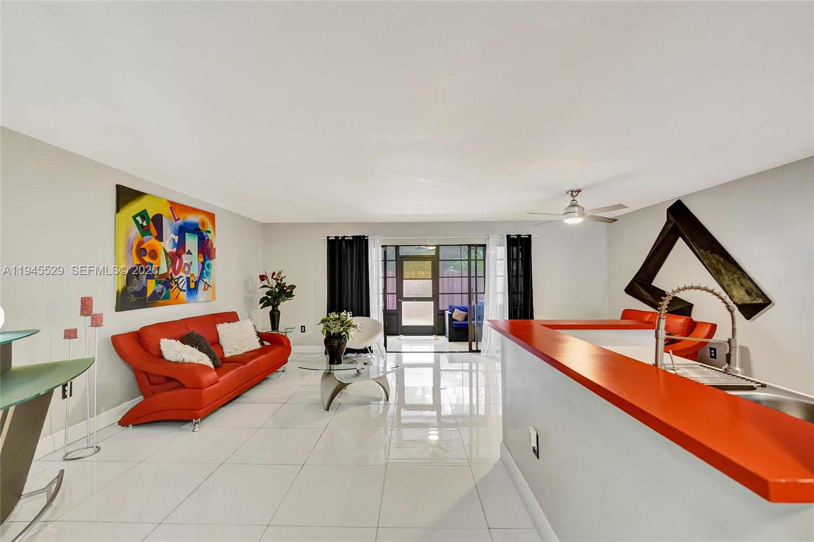 3301 Raleigh Street, Unit 4E Hollywood, FL 33021 - Photo 24 of 80 a living room with furniture a rug and white walls