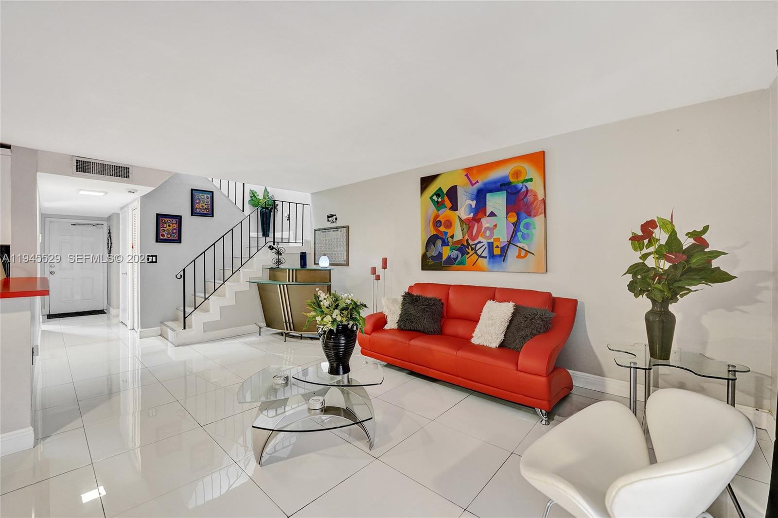 3301 Raleigh Street, Unit 4E Hollywood, FL 33021 - Photo 32 of 80 a living room with furniture and a potted plant