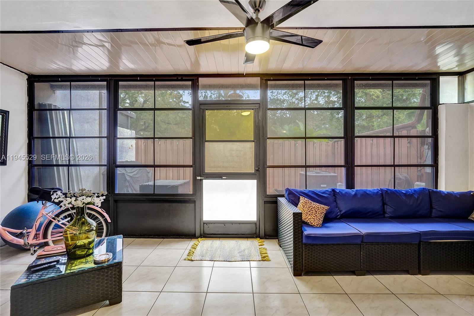 3301 Raleigh Street, Unit 4E Hollywood, FL 33021 - Photo 40 of 80 a living room with furniture a flat screen tv and a window
