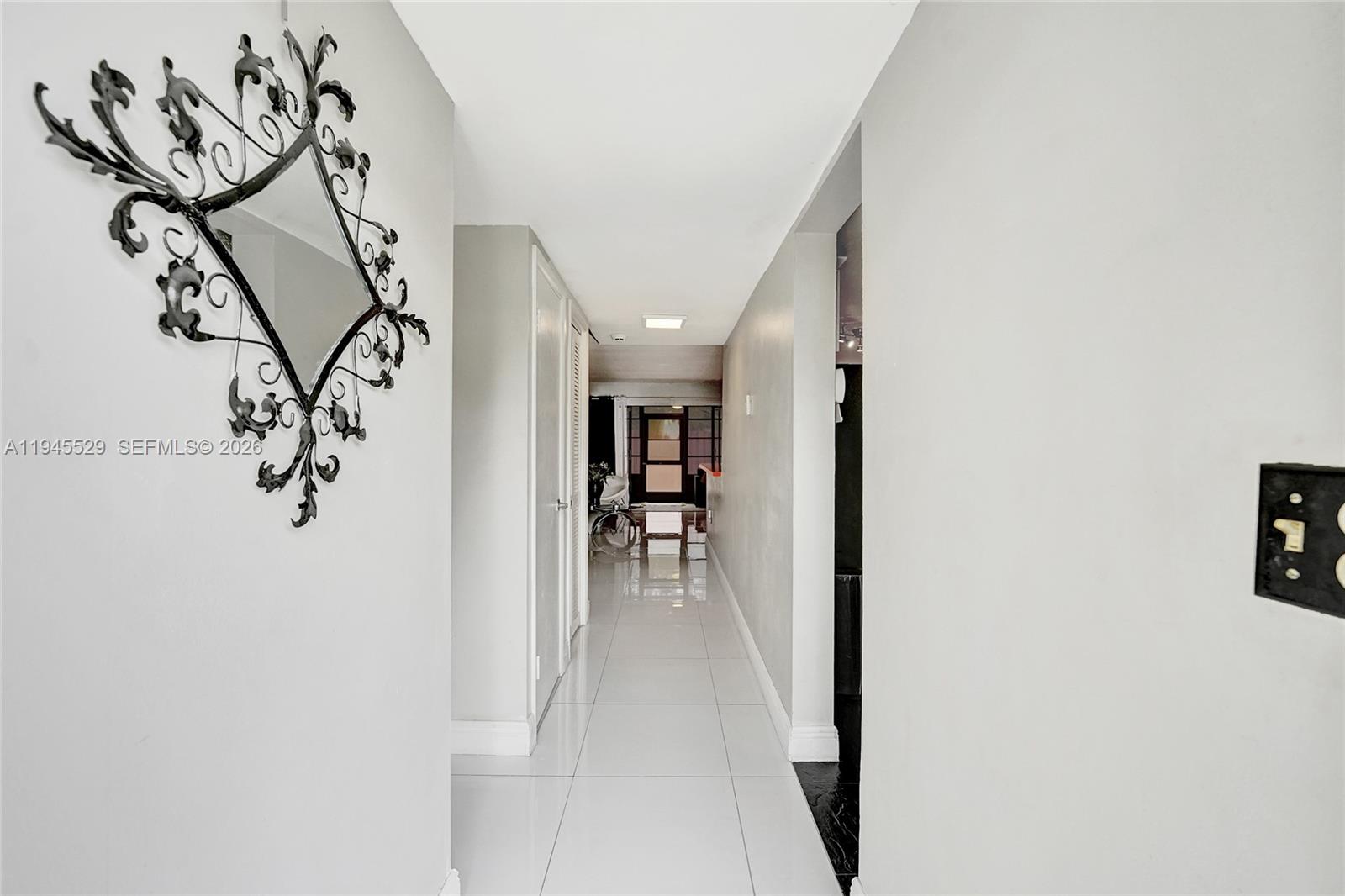 3301 Raleigh Street, Unit 4E Hollywood, FL 33021 - Photo 4 of 80 a view of a hallway with wooden floor and a potted plant