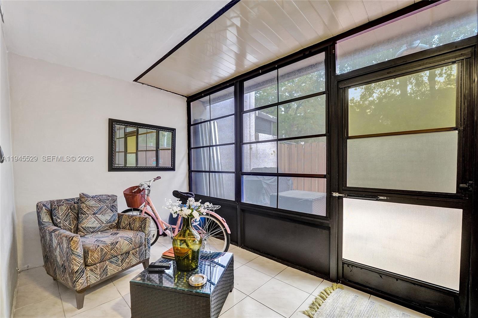 3301 Raleigh Street, Unit 4E Hollywood, FL 33021 - Photo 41 of 80 a living room with furniture a flat screen tv and a window
