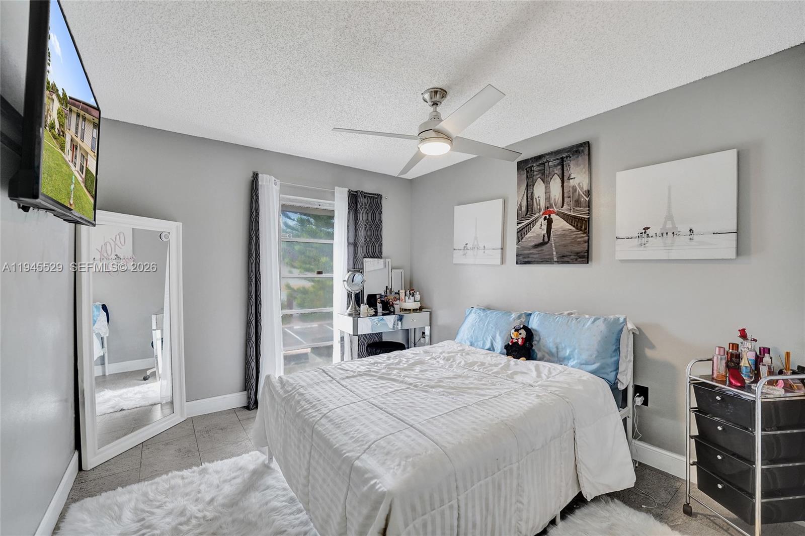 3301 Raleigh Street, Unit 4E Hollywood, FL 33021 - Photo 48 of 80 a bedroom with a large bed and a flat tv screen