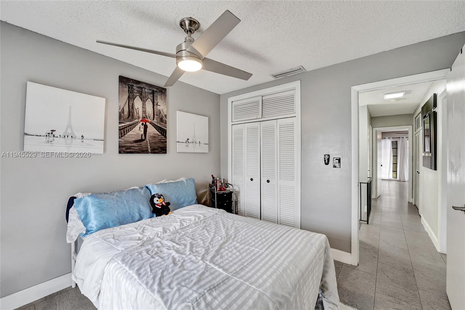 3301 Raleigh Street, Unit 4E Hollywood, FL 33021 - Photo 50 of 80 a bedroom with a bed and a chandelier