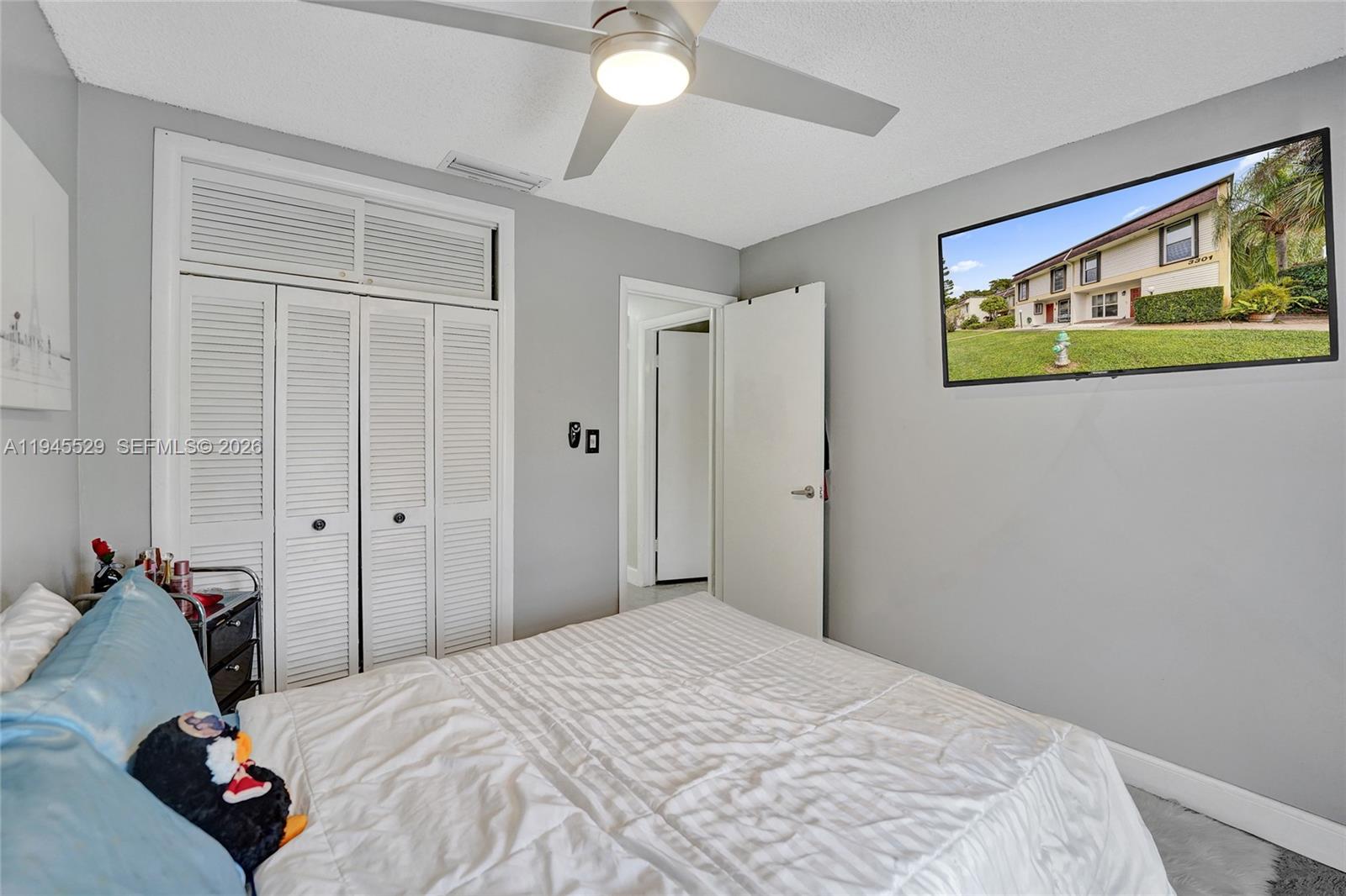 3301 Raleigh Street, Unit 4E Hollywood, FL 33021 - Photo 51 of 80 a bedroom with a bed and a window