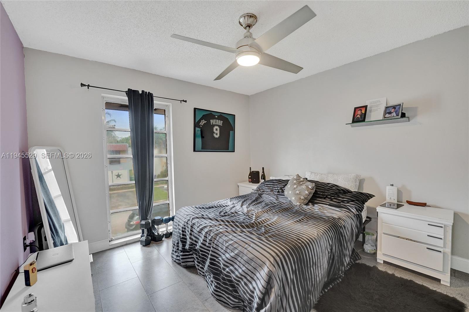 3301 Raleigh Street, Unit 4E Hollywood, FL 33021 - Photo 53 of 80 a bedroom with a bed and a flat screen tv