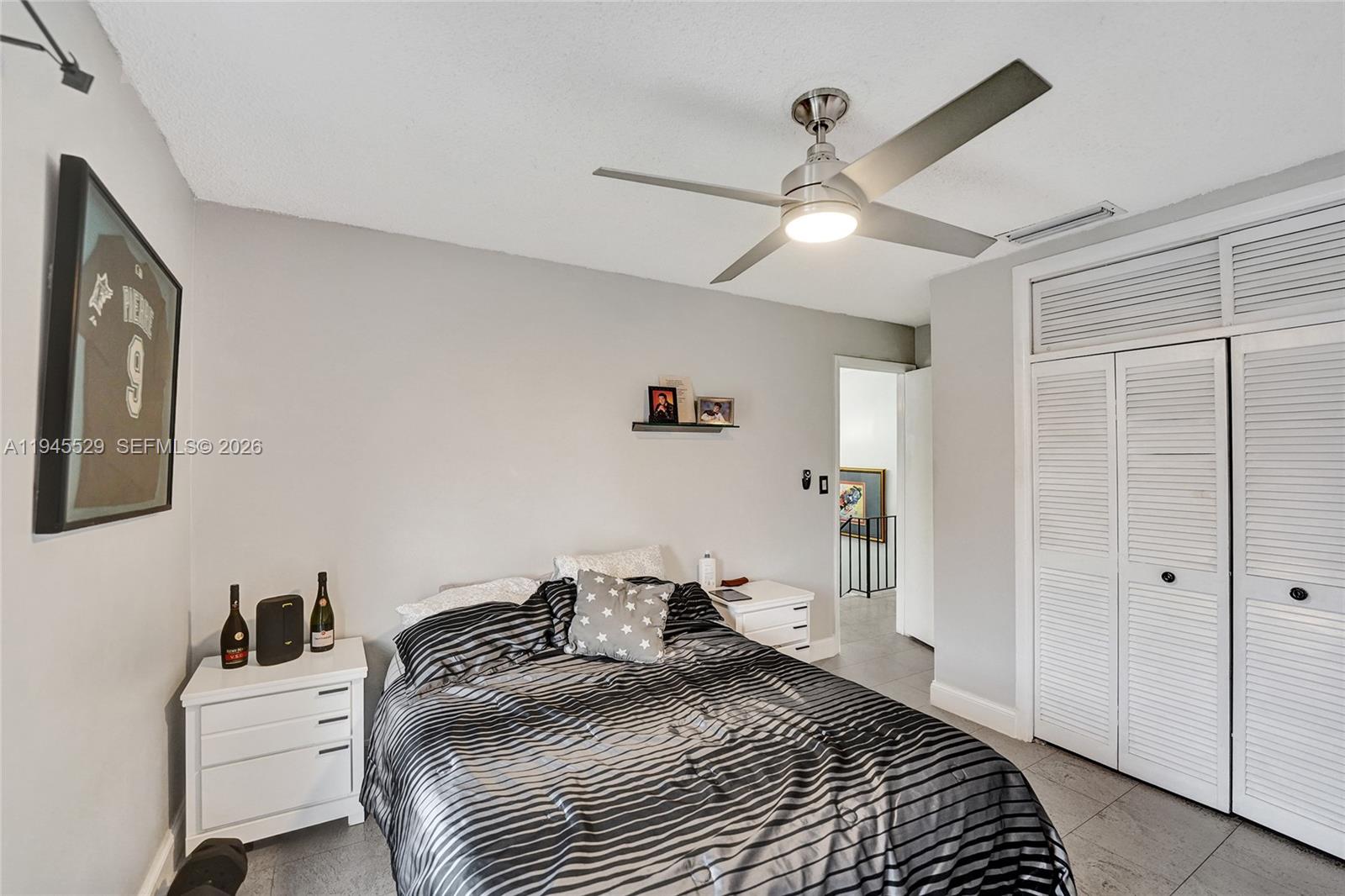 3301 Raleigh Street, Unit 4E Hollywood, FL 33021 - Photo 54 of 80 a bedroom with a bed and a chandelier