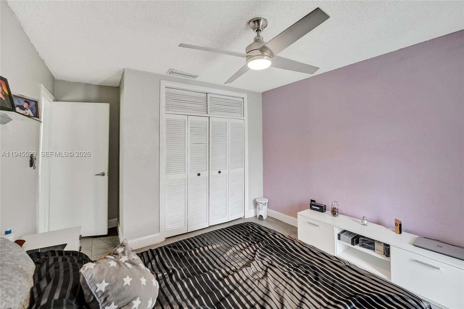 3301 Raleigh Street, Unit 4E Hollywood, FL 33021 - Photo 55 of 80 a bedroom with a bed and a chandelier